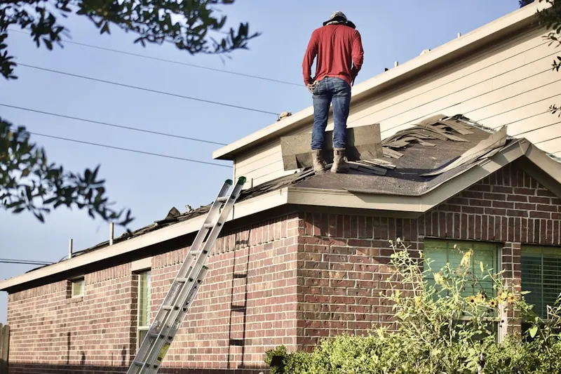 Professional roofer working on a residential roof in Hadley Greenleaf Historic District